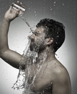 Man pouring water on himself