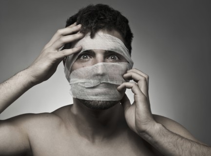 Man with bandages on his face