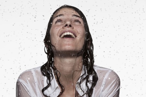 Rain falling on Caucasian businesswoman