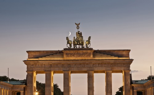 Columned building and statue lit up at night