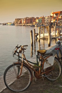 Bicycle parked by urban canal