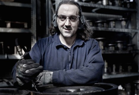 Caucasian worker operating machinery in factory