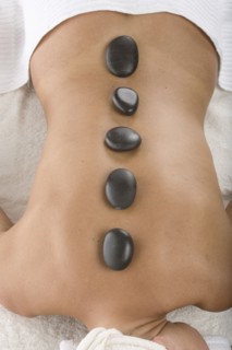 Caucasian woman having hot stone massage