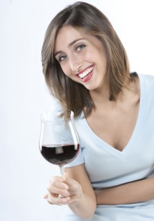 Smiling woman having glass of wine