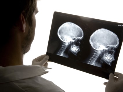 Caucasian doctor examining x-rays in hospital