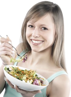 Hispanic woman eating salad