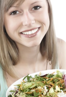 Hispanic woman eating salad