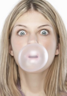 Woman blowing bubble gum bubble