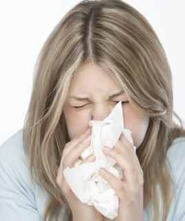 Woman blowing her nose