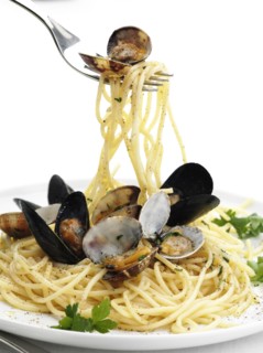 Close up of fork twirling pasta with seafood
