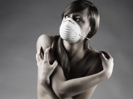 Naked Caucasian woman wearing pollution mask