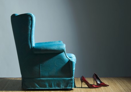 Red high heels near blue armchair