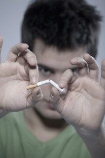 Caucasian man snapping cigarette