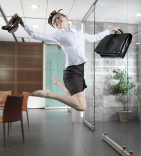 Caucasian businesswoman jumping in office