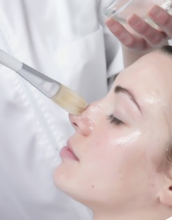 Caucasian woman receiving facial beauty treatment