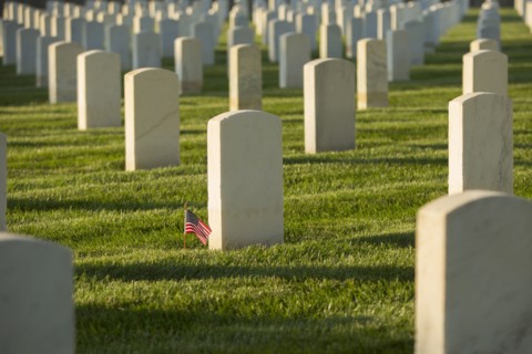 American flag at cemetery gravestone