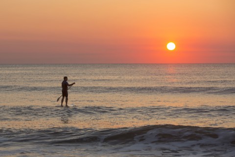 Silhouette of man on ocean