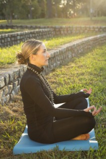 Caucasian woman meditating in park