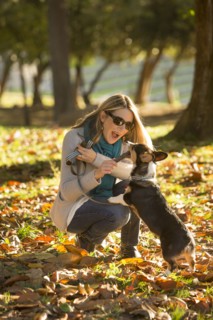 Caucasian woman playing with dog in park