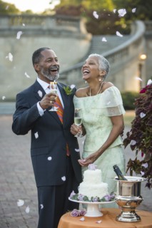 Flower petals falling on Black newlyweds