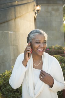 Black woman talking on cell phone near stone staircase
