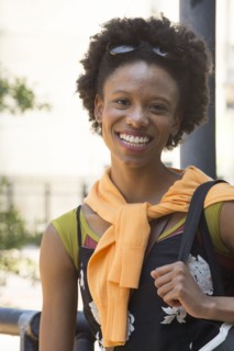 Portrait of smiling African American woman carrying purse