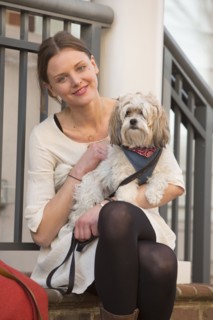 Portrait of Caucasian woman sitting on stoop holding dog