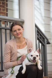 Portrait of Caucasian woman sitting on stoop holding dog