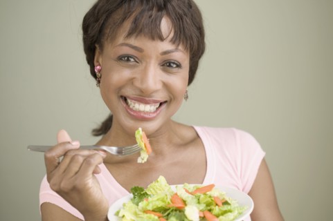 Portrait of woman eating salad