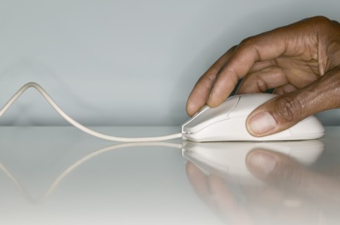 Close up of hands on computer mouse