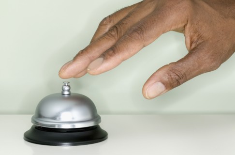 Close up of hand ringing service bell