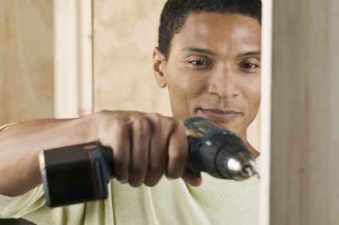 Man drilling hole with power drill