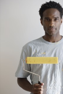 Portrait of man with paint roller