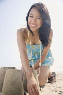 Portrait of woman building sandcastle