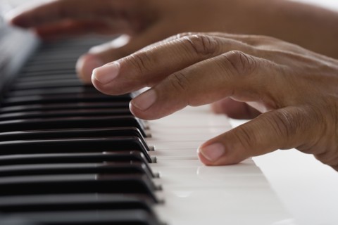 Close up of hands playing piano