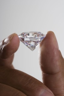 Close up of hand holding diamond