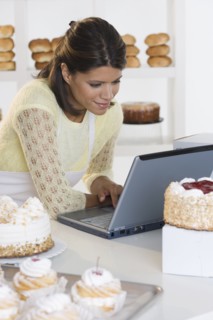 Woman at bakery working on laptop