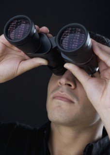 Man looking through binoculars