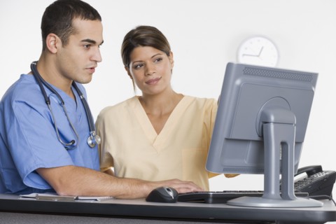 Nurses looking at computer monitor