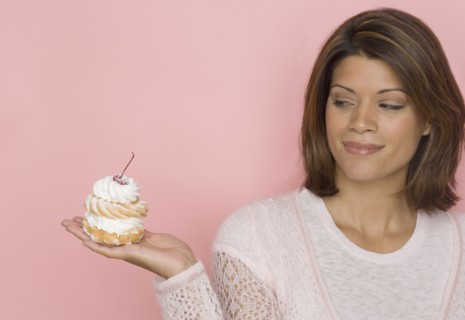 Portrait of woman holding pastry
