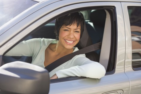 Portrait of woman sitting inside car