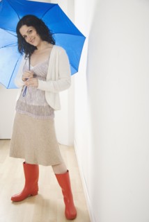 Portrait of woman with umbrella and rubber boots