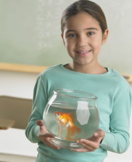 Young girl holding a fishbowl