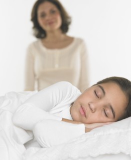 Mother watching her daughter sleep
