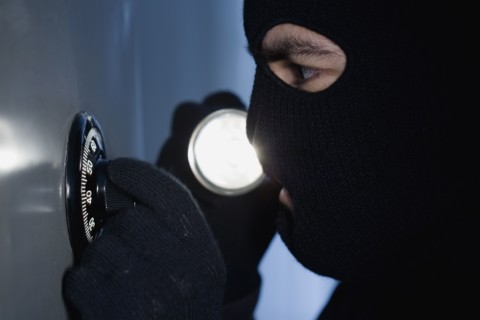 Thief unlocking a combination lock