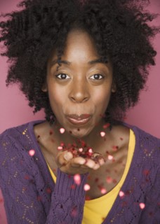 Young woman blowing confetti