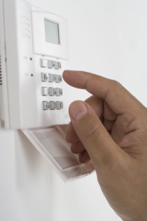 Close of African male hand using keypad