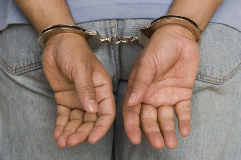 Close up of male hands in handcuffs