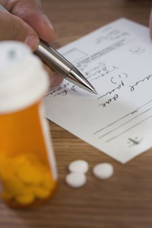 Close up of man filling out prescription