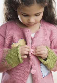 Young Hispanic girl buttoning sweater